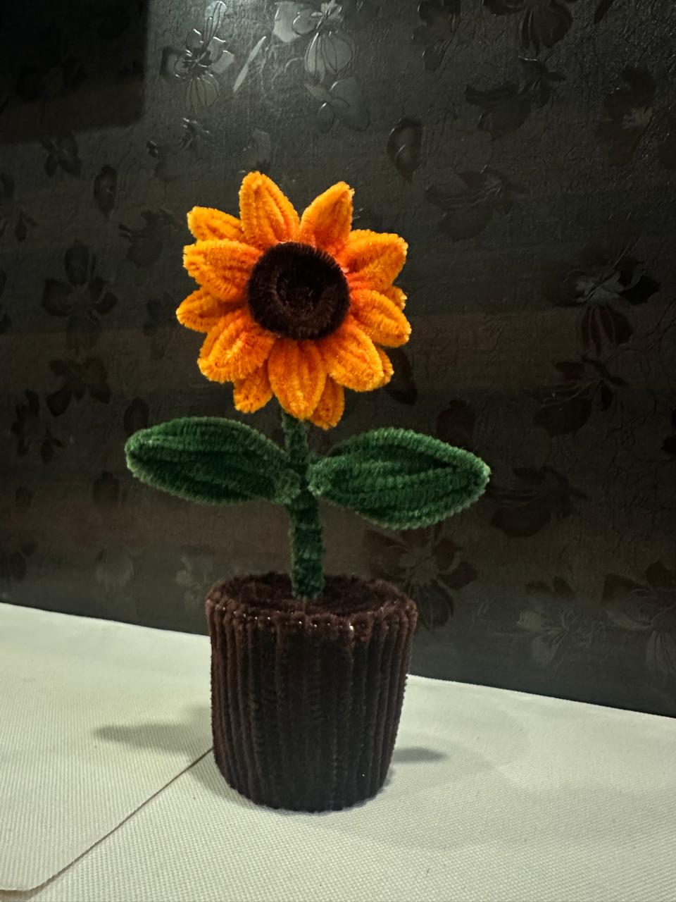 Handmade orange sunflower in a small dark pot